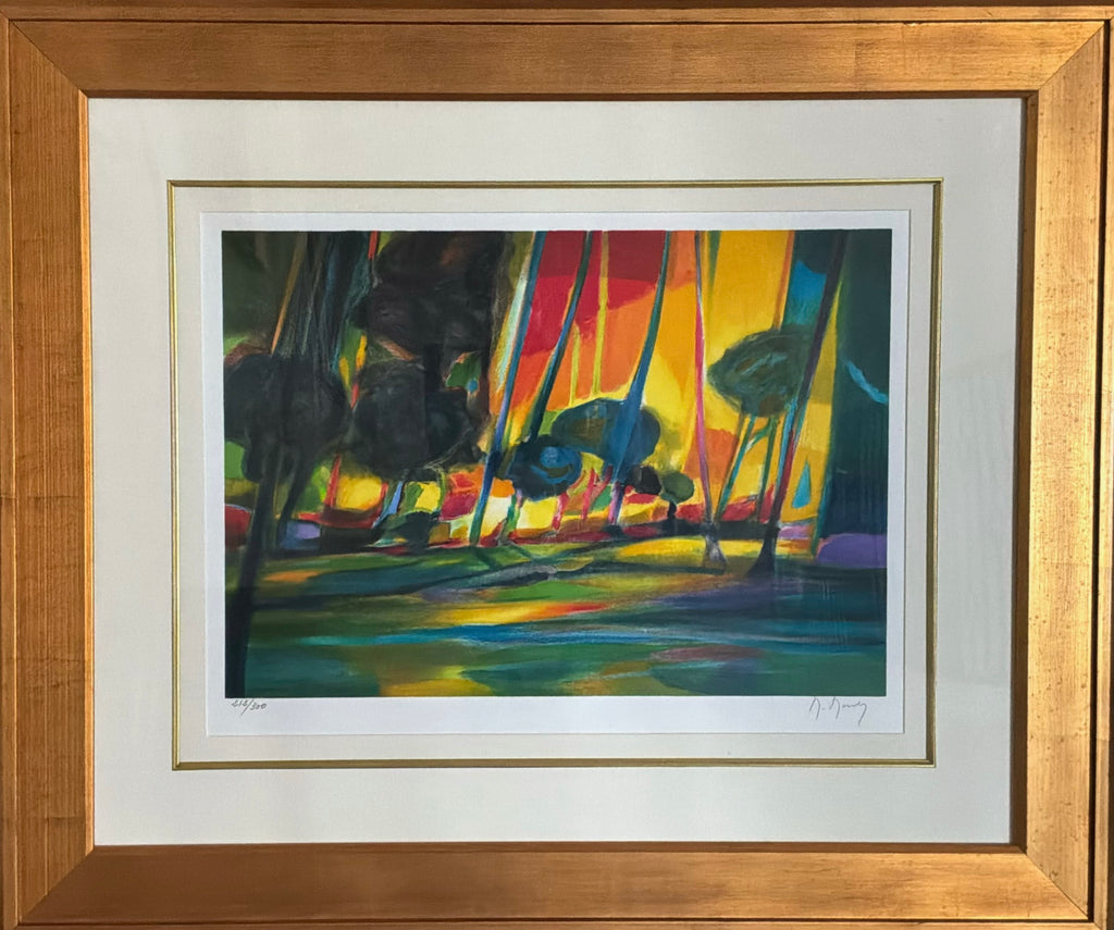A framed abstract landscape art print featuring vibrant vertical brushstrokes of yellow, red, green, blue, and black, presented in a light wood frame with a white mat board.